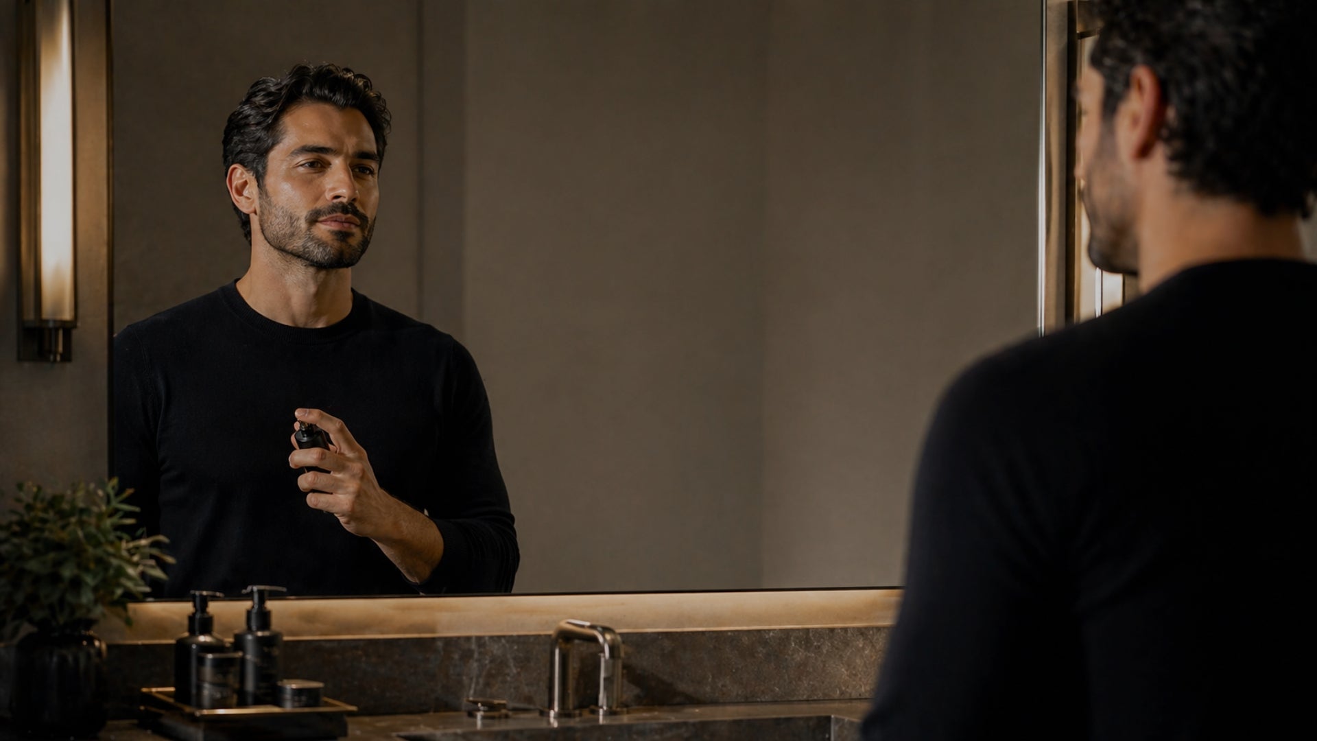Man applying makeup in front of a mirror in a bathroom.